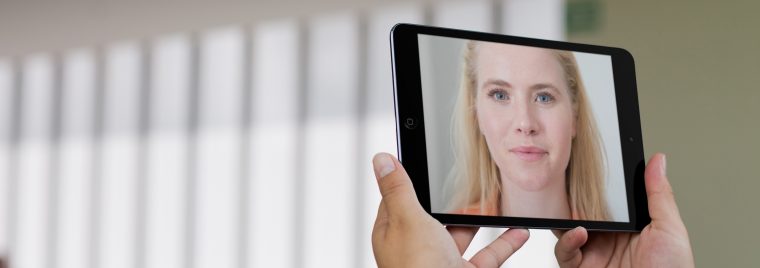 woman on a video call in front of a window