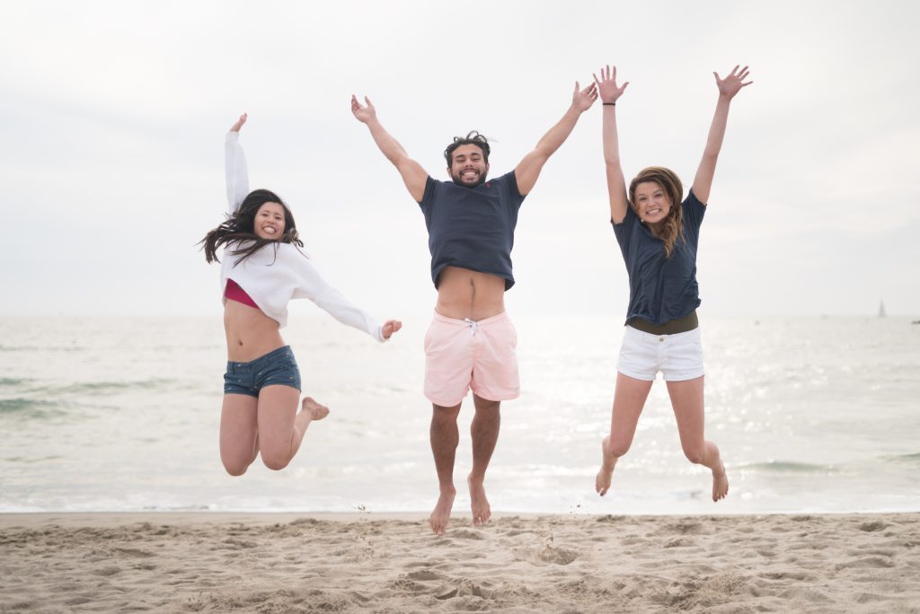 friends jumping on the beach - How to pose for your vacation photos